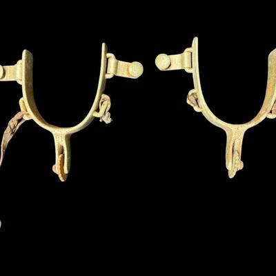 Sale Photo Thumbnail #252: These are most likely utilitarian “Texas Style” spurs. Possibly made by North & Judd. The leather straps are missing, and there is some nickel plate loss and rust. [KD]