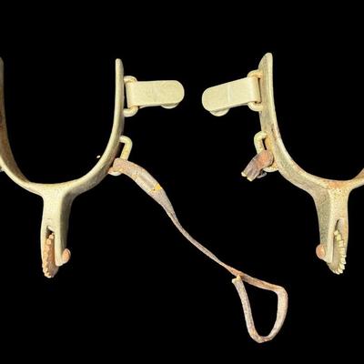 Sale Photo Thumbnail #251: These are most likely utilitarian “Texas Style” spurs. Possibly made by North & Judd. The leather straps are missing, and there is some nickel plate loss and rust. [KD]