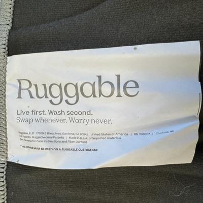 Sale Photo Thumbnail #254: This is a two-piece washable rug system, comprised of a rug cover and rug pad. It has a built-in waterproof barrier. It is stain resistant, water resistant, and machine washable. Glen Plaid pattern. Age related wear. Measurement: 120”L x 30”W. [RS]