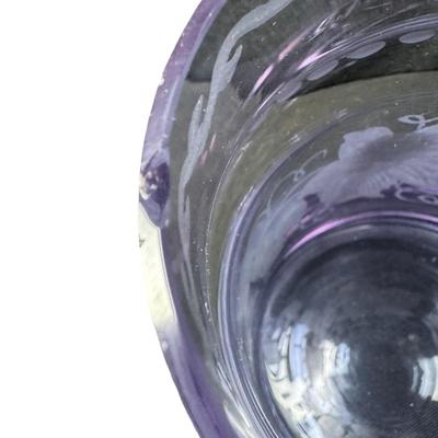 Sale Photo Thumbnail #289: Made in Czechoslovakia. Includes two purple etched beer mugs, and one amber delicate glass vase. Total of three pieces. One of the mugs has a chip on the rim (pictured). Measurement of tallest: 7”H. Pre-auction estimate: $75-$125. [RE]