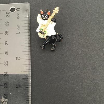 Sale Photo Thumbnail #174: Very cute black and white enamel cat playing banjo brooch please see attached photos