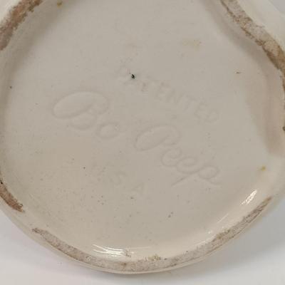 LOT 61: Shawnee Pottery Bo Peep Pitcher, Artini Arts Sculptured Engravings, Wedgwood Peter Rabbit Coin Bank & More