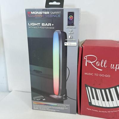 LOT 82: NIP Novelty & More: Light Bar+, Golden Girls Coasters, Roll-up Piano & More