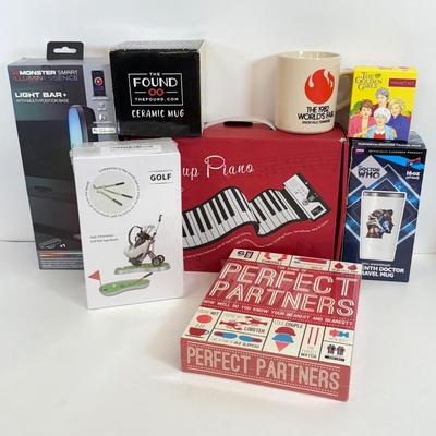 LOT 82: NIP Novelty & More: Light Bar+, Golden Girls Coasters, Roll-up Piano & More