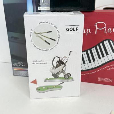 LOT 82: NIP Novelty & More: Light Bar+, Golden Girls Coasters, Roll-up Piano & More