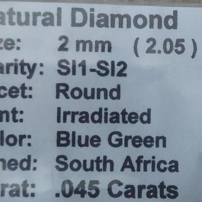 0.045 carat irradiated blue-green diamond