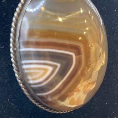 Victorian Scottish banded agate brooch with a polished oval-shaped stone set in a bezel setting