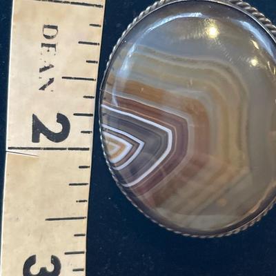 Victorian Scottish banded agate brooch with a polished oval-shaped stone set in a bezel setting