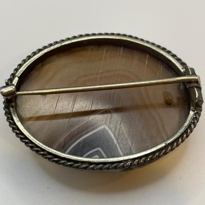 Victorian Scottish banded agate brooch with a polished oval-shaped stone set in a bezel setting