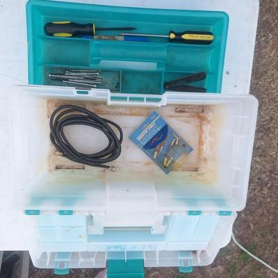 plastic toolbox with a few tools.