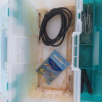 plastic toolbox with a few tools.