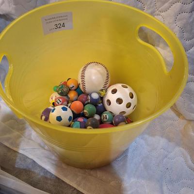bucket of bouncy balls, a baseball and others