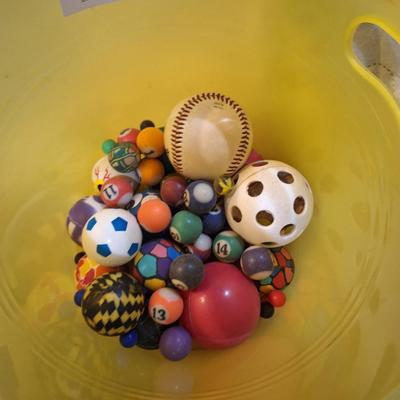 bucket of bouncy balls, a baseball and others