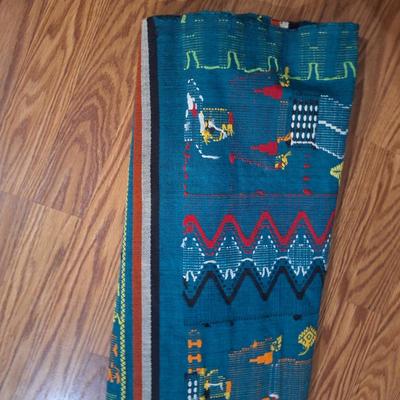 handwoven Guatemalan textile or tapestry, depicting human figures and animal motifs. 