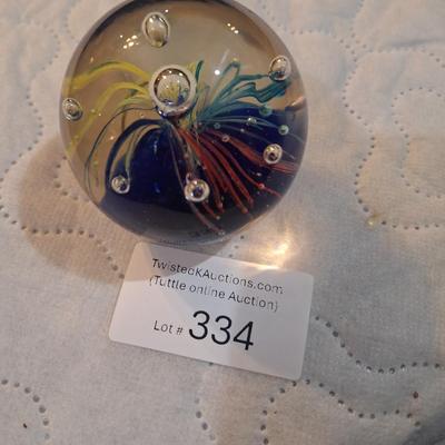 vintage hand-blown art glass paperweight, featuring a "firework" or "flower burst" design with controlled bubbles. 