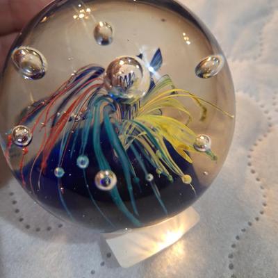 vintage hand-blown art glass paperweight, featuring a "firework" or "flower burst" design with controlled bubbles. 