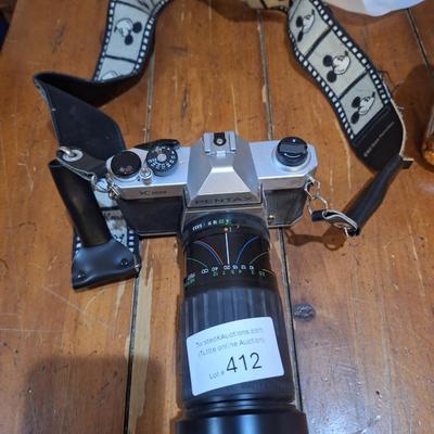 vintage Pentax K1000 35mm film with a 50mm vivitar lens and mickey mouse strap