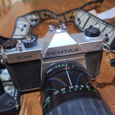 vintage Pentax K1000 35mm film with a 50mm vivitar lens and mickey mouse strap