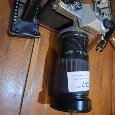 vintage Pentax K1000 35mm film with a 50mm vivitar lens and mickey mouse strap