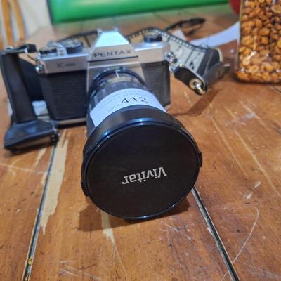 vintage Pentax K1000 35mm film with a 50mm vivitar lens and mickey mouse strap