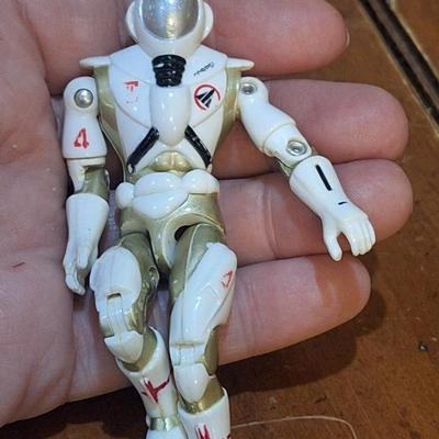 2 small action figures:1994 vanard the corps star force sapper astronaut figure on the right and GI joe action figure on the left from 2002