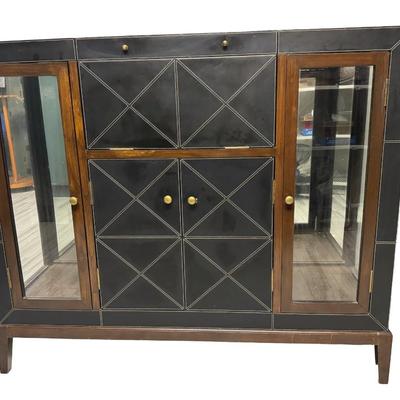 Sale Photo Thumbnail #323: This features black leather panels over wood. There is a mixture of glass and wood fronts. The center of the unit lifts to reveal a bar with plenty of storage for liquor. Glass shelves and hardware are included. The legs may need to be tightened. Measurem