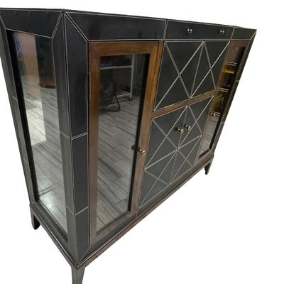 Sale Photo Thumbnail #327: This features black leather panels over wood. There is a mixture of glass and wood fronts. The center of the unit lifts to reveal a bar with plenty of storage for liquor. Glass shelves and hardware are included. The legs may need to be tightened. Measurem
