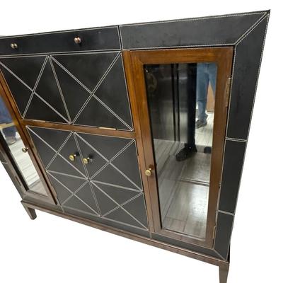 Sale Photo Thumbnail #326: This features black leather panels over wood. There is a mixture of glass and wood fronts. The center of the unit lifts to reveal a bar with plenty of storage for liquor. Glass shelves and hardware are included. The legs may need to be tightened. Measurem