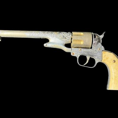 Sale Photo Thumbnail #351: Includes a wooden juvenile accordion, a vintage Colt .45 diecast cap gun, and a “Pigget” character card game. The bellows are intact on the accordion. All pieces have age related wear. Not tested. Measurement of accordion: 9”L (approximate). [SR]