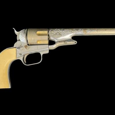 Sale Photo Thumbnail #350: Includes a wooden juvenile accordion, a vintage Colt .45 diecast cap gun, and a “Pigget” character card game. The bellows are intact on the accordion. All pieces have age related wear. Not tested. Measurement of accordion: 9”L (approximate). [SR]