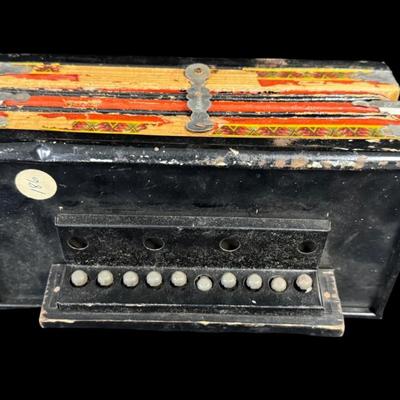 Sale Photo Thumbnail #348: Includes a wooden juvenile accordion, a vintage Colt .45 diecast cap gun, and a “Pigget” character card game. The bellows are intact on the accordion. All pieces have age related wear. Not tested. Measurement of accordion: 9”L (approximate). [SR]