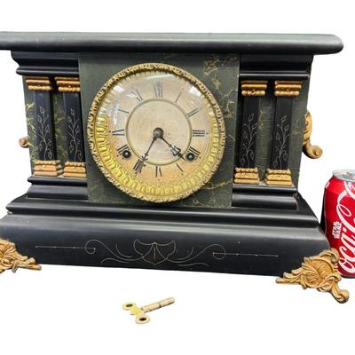 Sale Photo Thumbnail #375: This is black enameled on wood, and has a decorative brass bezel around ornamental pillars, or columns. Includes key. Age related wear. Not tested. Measurement: 15”W x 11”H x 6.5”D. [SR]