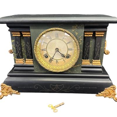 Sale Photo Thumbnail #373: This is black enameled on wood, and has a decorative brass bezel around ornamental pillars, or columns. Includes key. Age related wear. Not tested. Measurement: 15”W x 11”H x 6.5”D. [SR]