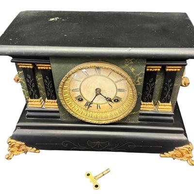 Sale Photo Thumbnail #374: This is black enameled on wood, and has a decorative brass bezel around ornamental pillars, or columns. Includes key. Age related wear. Not tested. Measurement: 15”W x 11”H x 6.5”D. [SR]