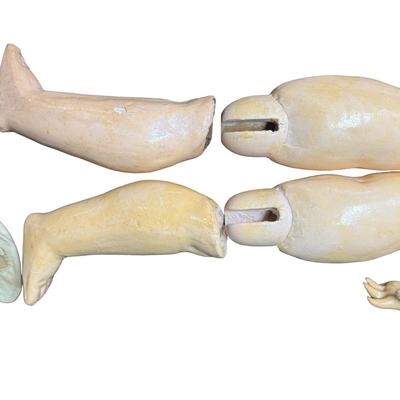 Sale Photo Thumbnail #379: This doll body is missing the head. It is made of bisque. Includes a dress and knickers. Age related wear. Measurement: 20”L (without head). Pre-auction: $50-$100. [SR]