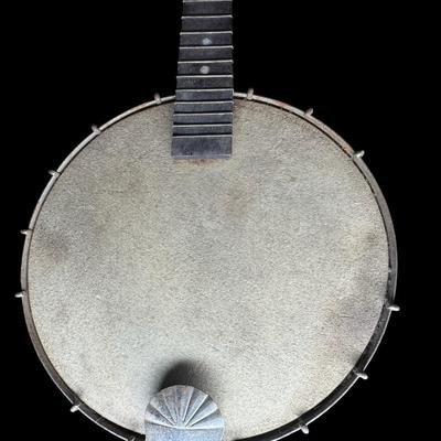 Sale Photo Thumbnail #391: Includes a mandolin banjo, and what is believed to be a 19th century J.H. Buckbee banjo. Both are nickel plated, open back banjos. Both need to be repaired. Measurement of largest: 35”L. [KD]