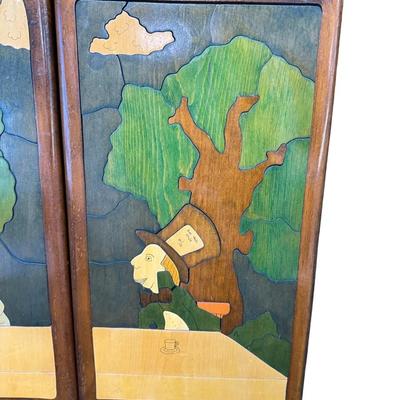 Sale Photo Thumbnail #431: This vintage piece is in four panels. It depicts a scene from the story, including Alice, The Mad Hatter, and other characters. This has great vintage patina. There are some minor cracks on the framing only, and a few areas of scratches on the puzzle piec