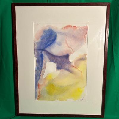 Sale Photo Thumbnail #77: Framed abstract watercolor painting featuring red, blue, and yellow hues blending together in a fluid composition. The artwork is displayed in a wooden frame with a white matte board. The artist's signature is visible in the bottom corner of the piece. Ar