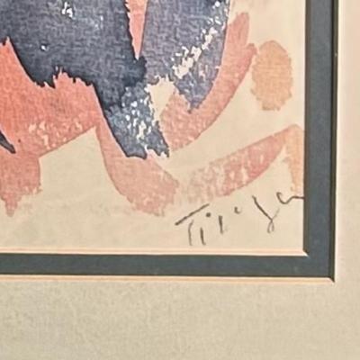 Sale Photo Thumbnail #111: A framed abstract watercolor print featuring a mix of vibrant blues, greens, oranges, and reds, with organic shapes and brushstrokes. The piece is set within a double mat and enclosed in a metallic finish frame. The lower right corner contains an artist's