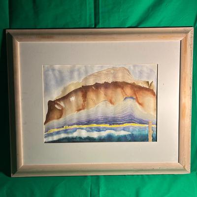 Sale Photo Thumbnail #114: Framed abstract watercolor painting depicting a landscape with warm earthy and cool blue tones. The artwork is surrounded by a white mat and encased in a light wood frame. The painting surface shows no visible damage, and the frame exhibits minor wear con