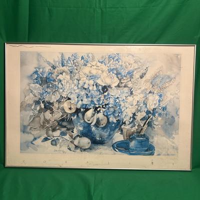 Sale Photo Thumbnail #125: Watercolor painting depicting a still life arrangement of flowers, fruit, and a blue vase. Rendered in a blue and neutral color palette, the composition emphasizes soft, natural forms. The artwork is presented in a thin white frame with glazing. Artist’
