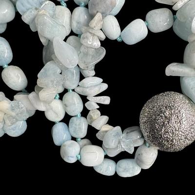 Sale Photo Thumbnail #498: Includes a raw aquamarine necklace, a red coral necklace, and a pearl necklace. Two of the necklaces have matching earrings. [ES]