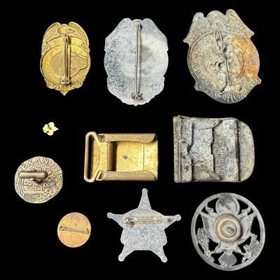 Sale Photo Thumbnail #512: Includes badges, belt buckles, and more. Total of nine pieces. Various metal compositions. Measurement of largest: 2.5”. [KD]