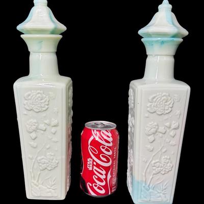 Sale Photo Thumbnail #516: Two green slag glass bottles. No obvious chips or cracks. Measurement: 12”H (each). Pre-auction estimate: $25-$50. [KD]