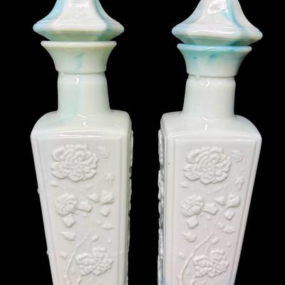 Sale Photo Thumbnail #513: Two green slag glass bottles. No obvious chips or cracks. Measurement: 12”H (each). Pre-auction estimate: $25-$50. [KD]