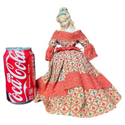 Sale Photo Thumbnail #535: This doll has a bisque head, and an articulating wooden body. It is believed to be made in Japan for U.S. import. The doll is wearing a Victorian style dress. The stand is included. Measurement of doll: 9.5”H. [JS]