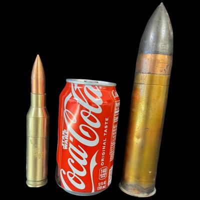 Sale Photo Thumbnail #546: Includes an inert shell casing, and a lighter bullet. Total of two pieces. Measurement of tallest: 8”H (shell). [JS]