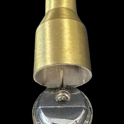 Sale Photo Thumbnail #544: Includes an inert shell casing, and a lighter bullet. Total of two pieces. Measurement of tallest: 8”H (shell). [JS]