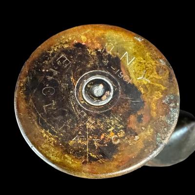 Sale Photo Thumbnail #543: Includes an inert shell casing, and a lighter bullet. Total of two pieces. Measurement of tallest: 8”H (shell). [JS]