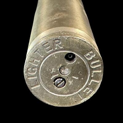 Sale Photo Thumbnail #545: Includes an inert shell casing, and a lighter bullet. Total of two pieces. Measurement of tallest: 8”H (shell). [JS]